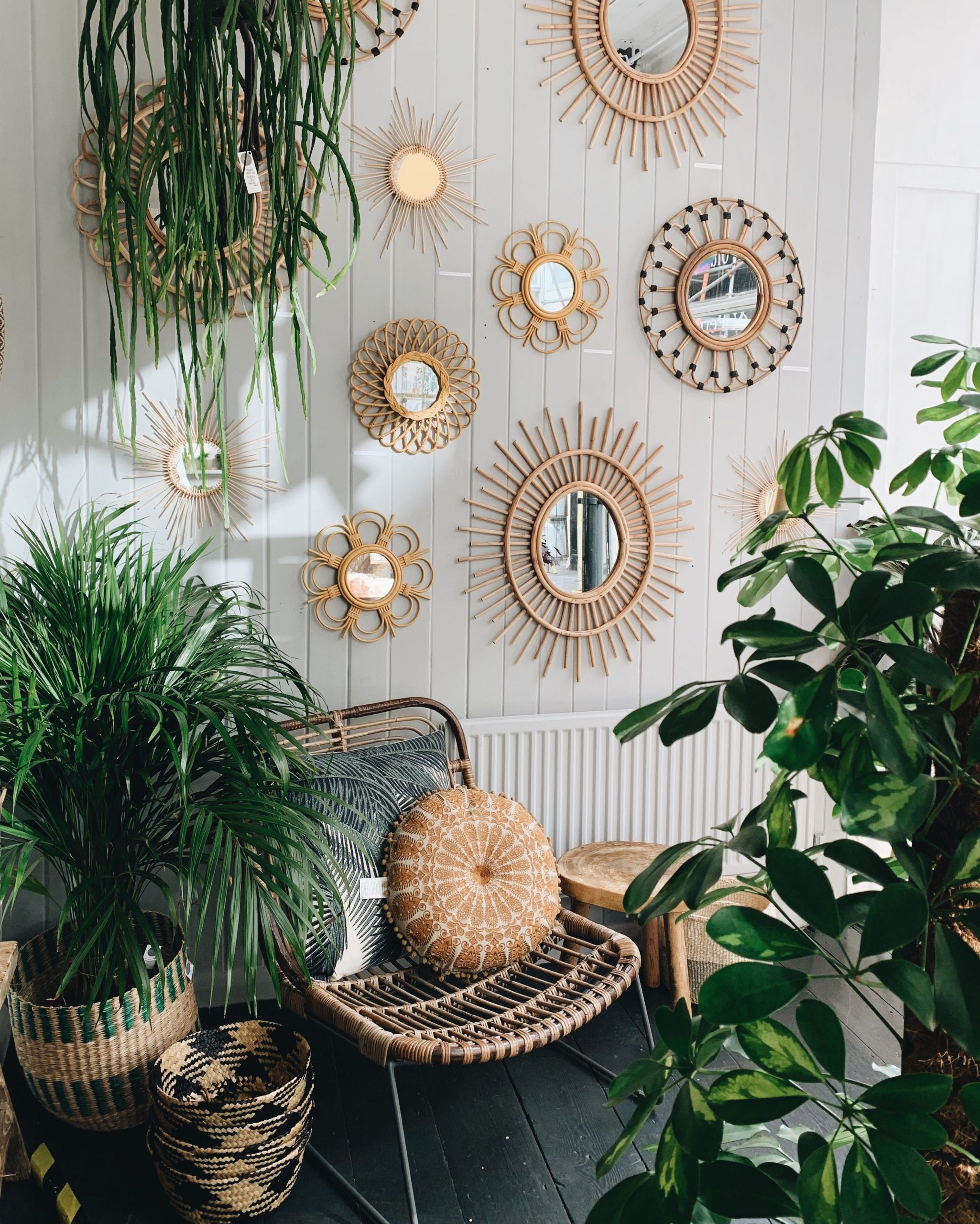 bohemian interior with rattan mirrors and plants