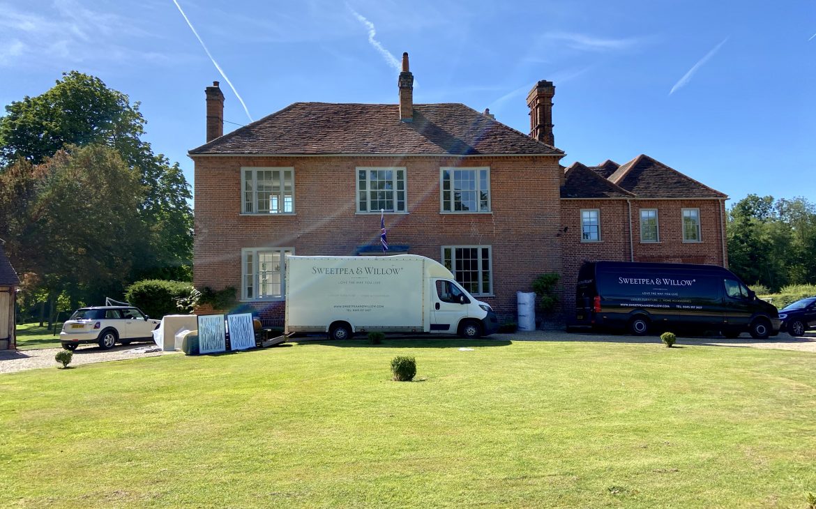 an exterior short of a large house with a fairly clear blue sky