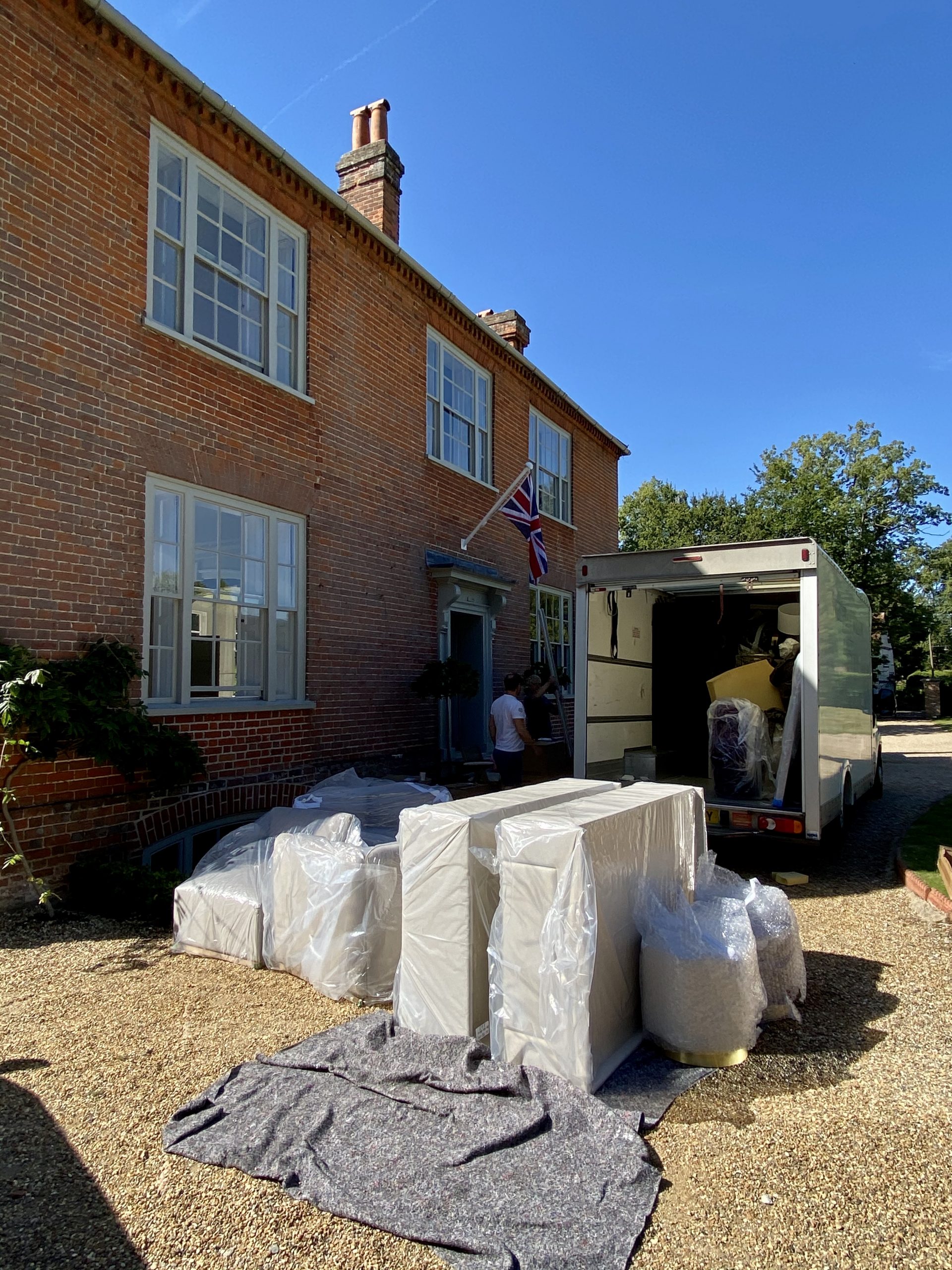 a shot of packaged furniture outside a house