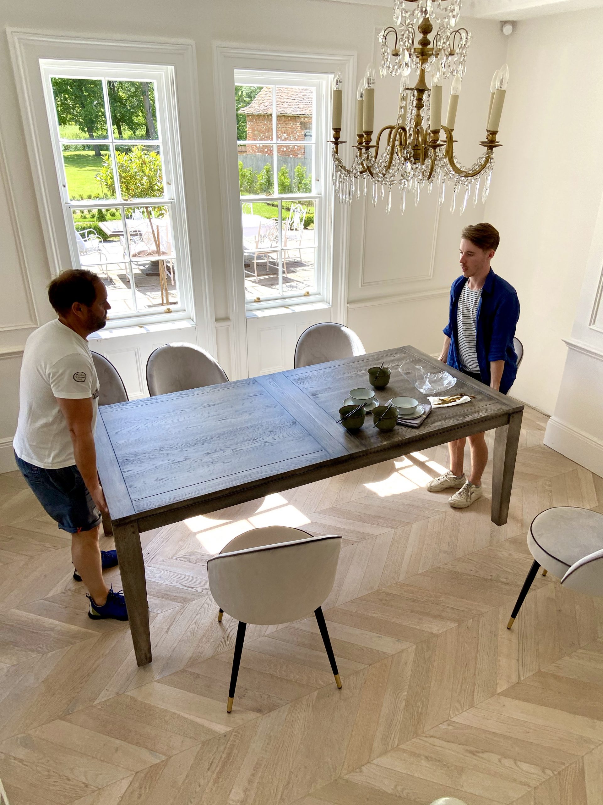 two men lifting a luxurious dining table