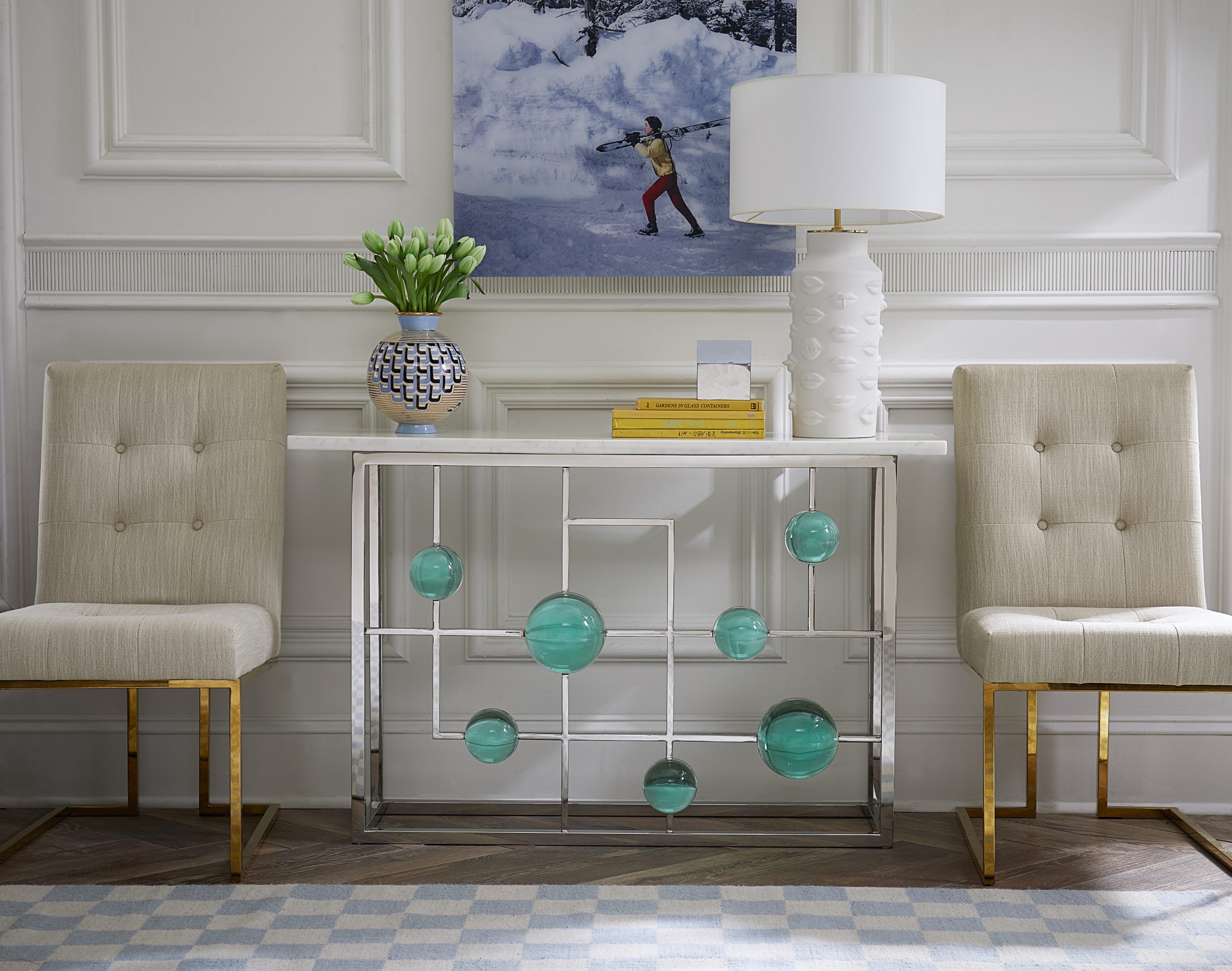a luxurious console table with chairs, a lamp and other decorative pieces