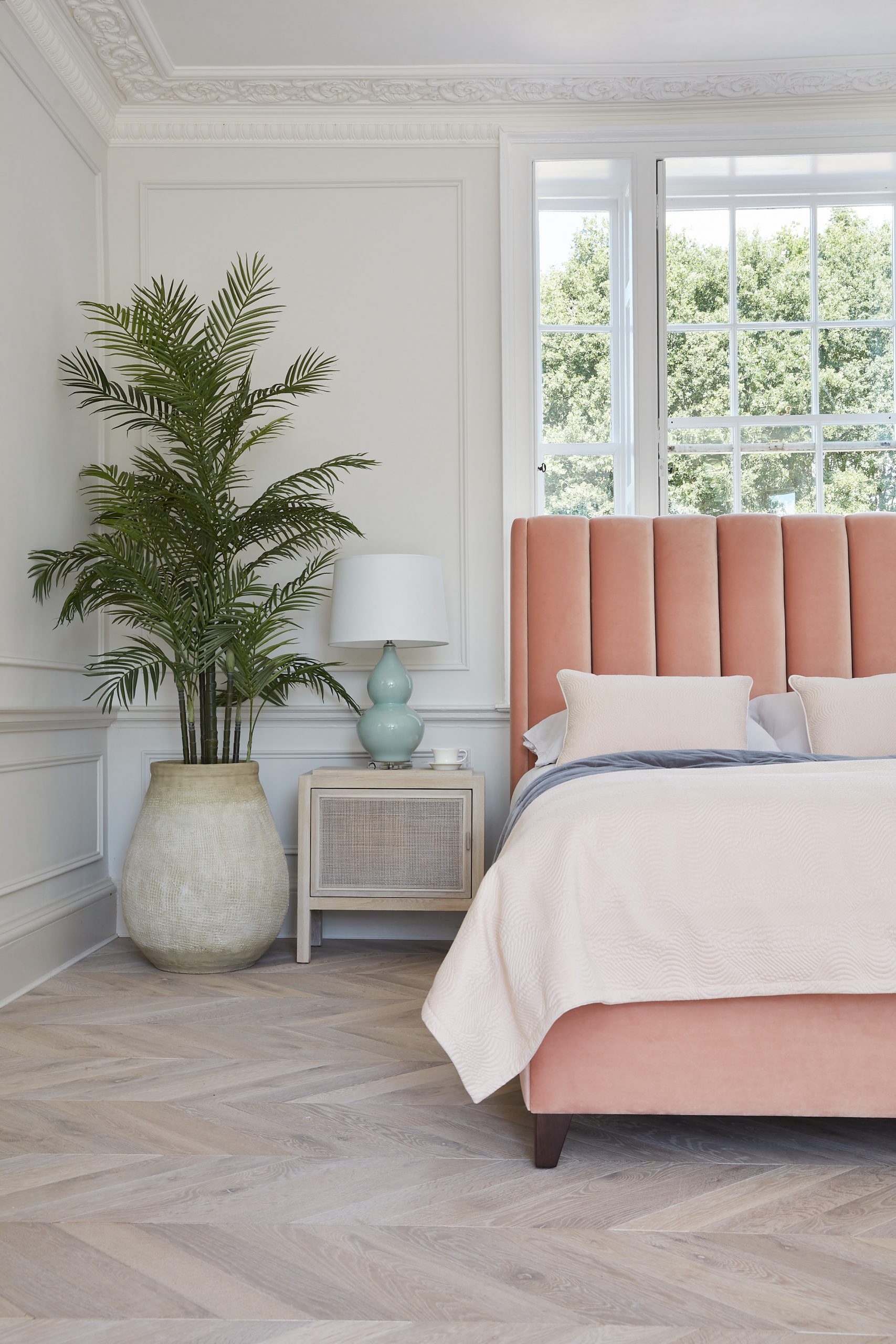 bedroom with large pink bed and other furnishings