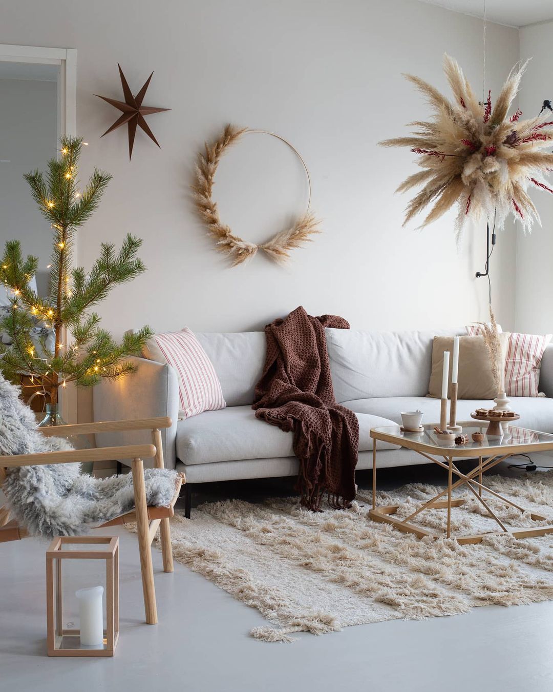 A Christmassy living room with decorations and soft furnishings  