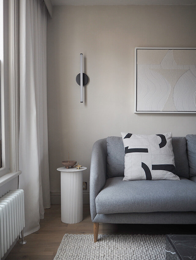 a minimalist grey-scale living room