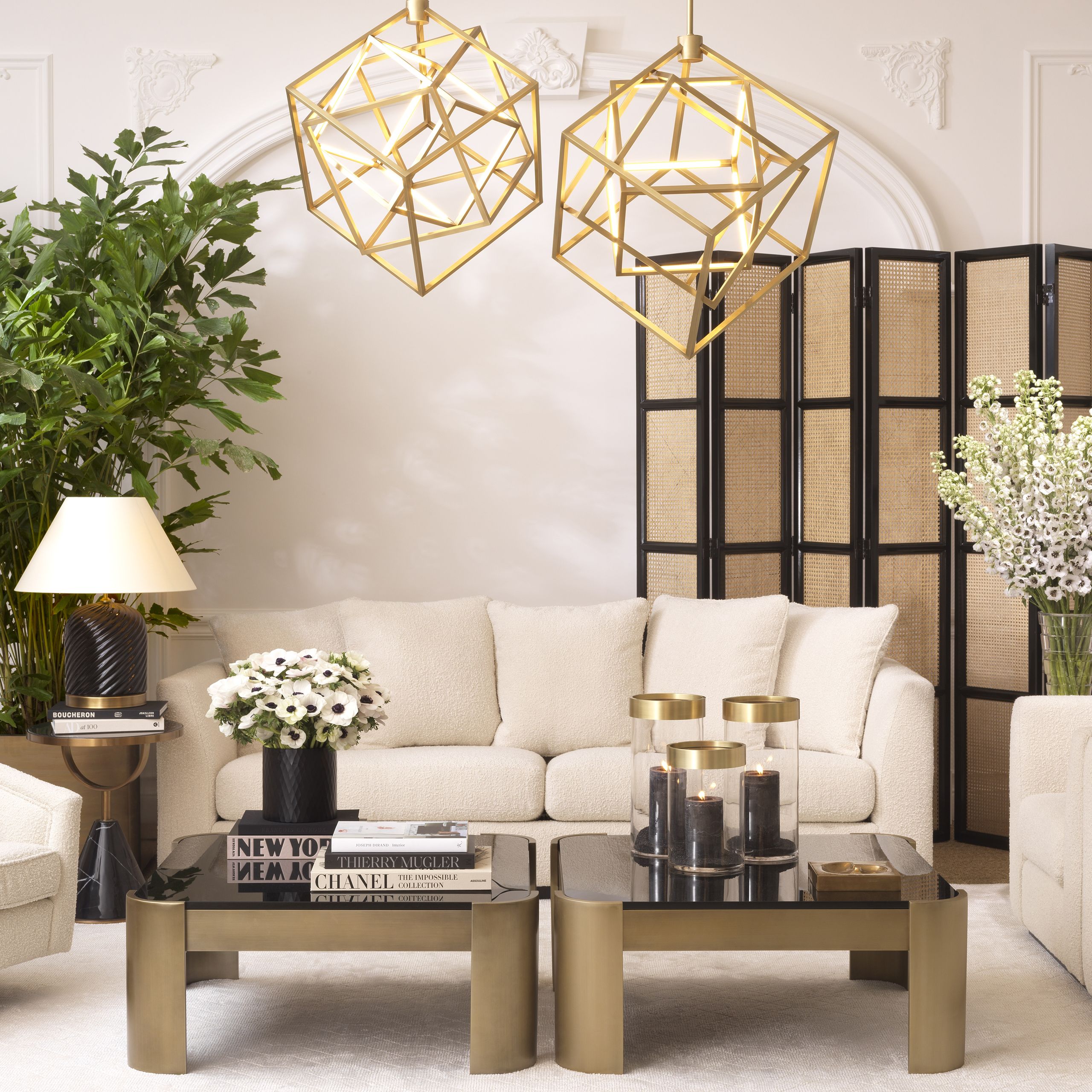 a fabulous living room with brass, rattan and boucle furniture