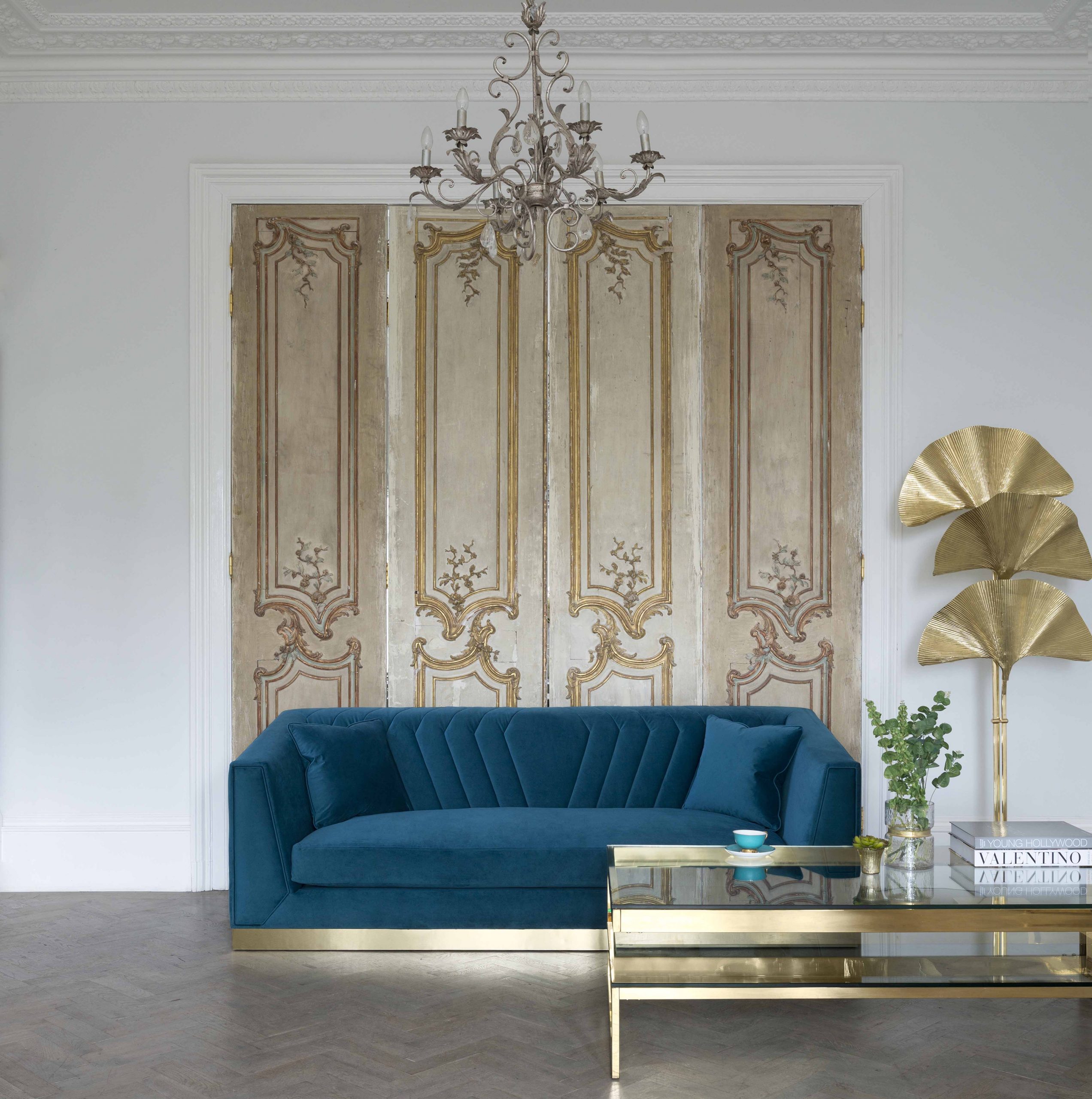 A luxurious teal-toned sofa in a elegant living space