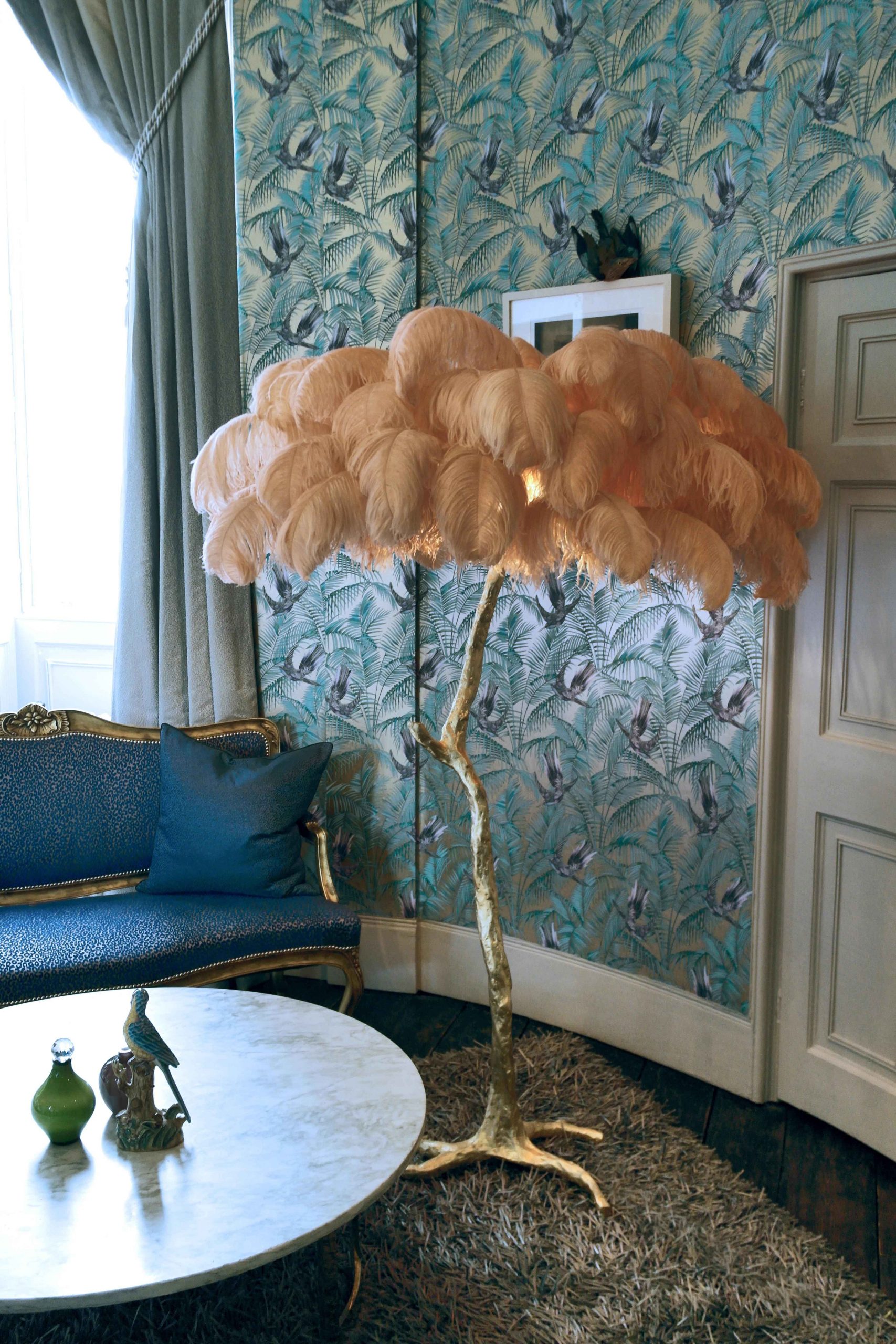 a fabulous peach-coloured feather floor lamp in an opulent space