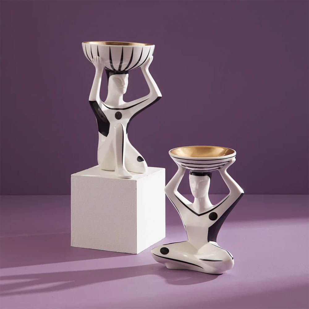 Black and white porcelain Budapest figure carrying gold-lined bowl