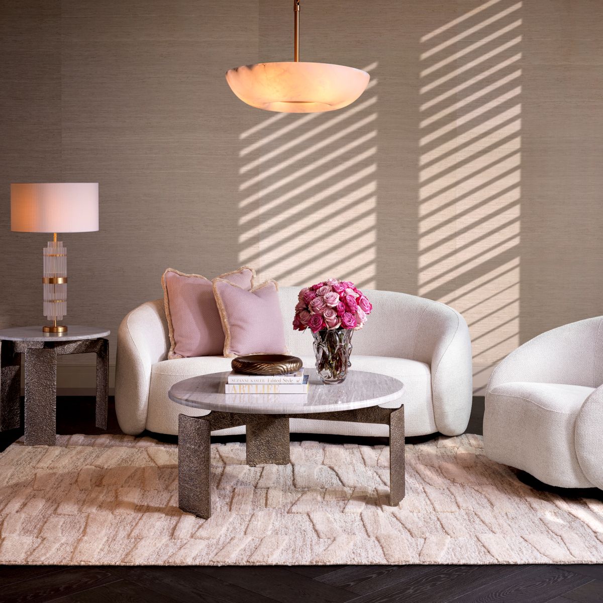 Off white sofa with curved back and a sleek black base