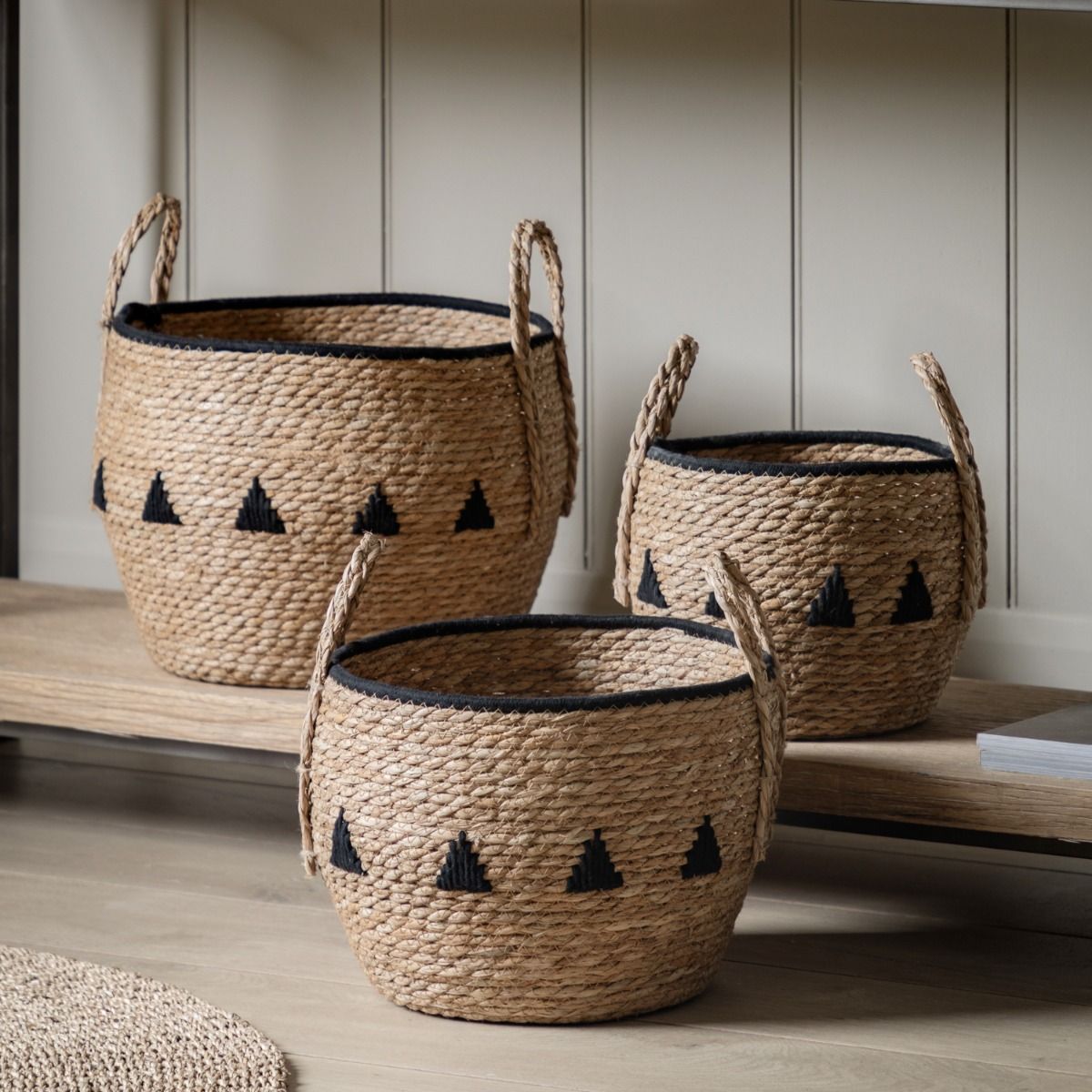 Set of three woven baskets with black detailing