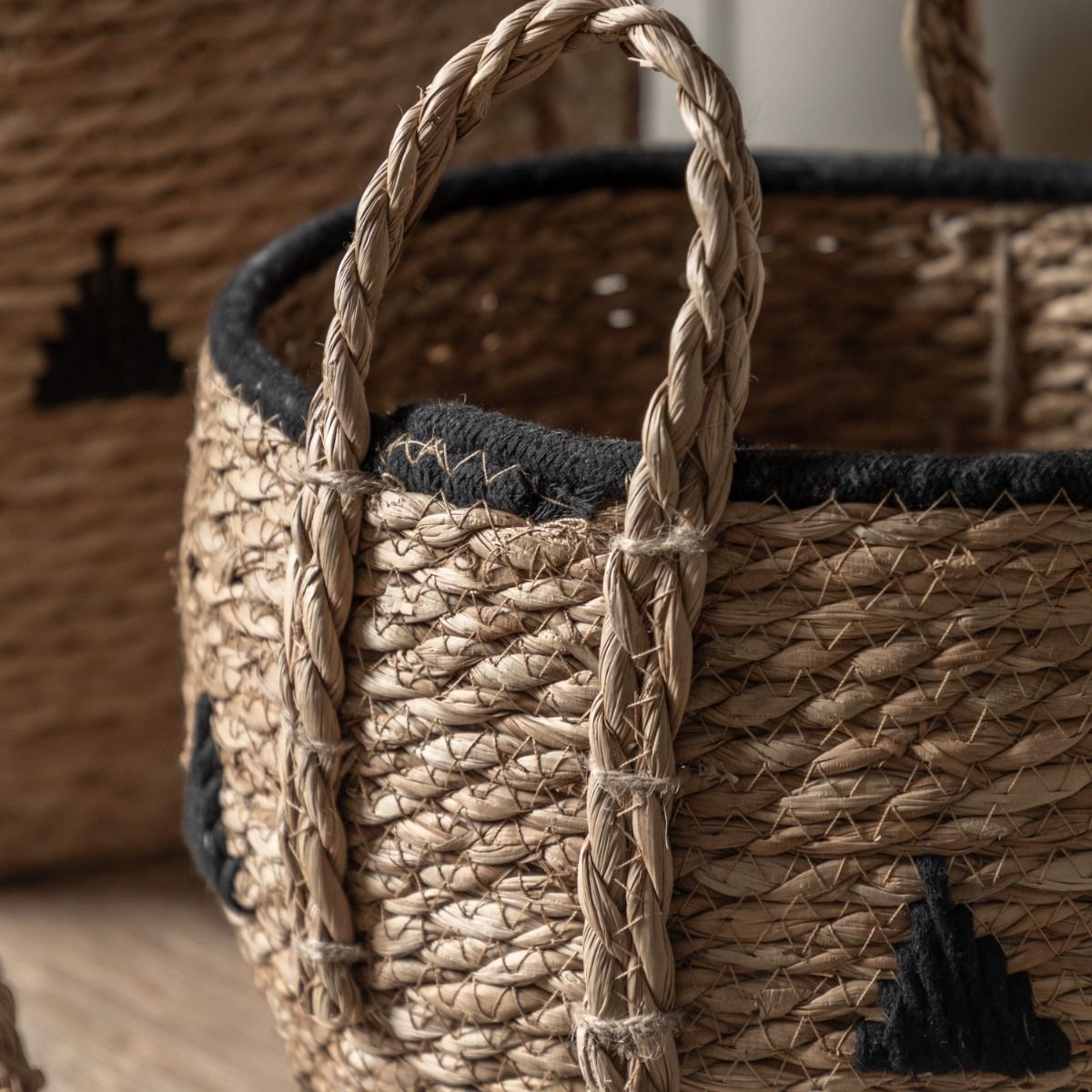 Set of three woven baskets with black detailing