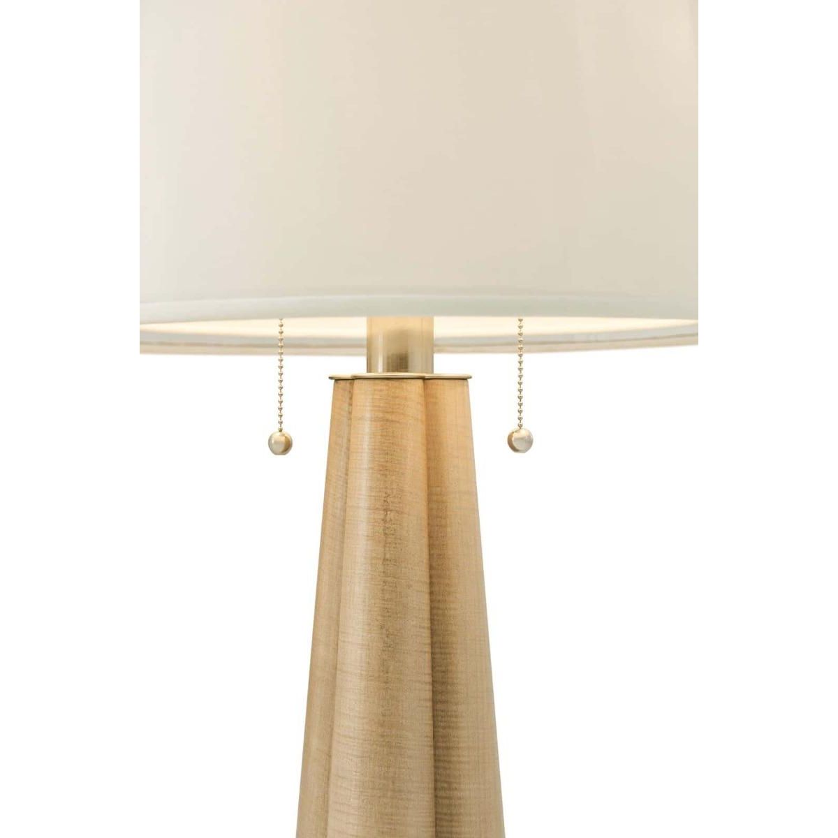 Side lamp with a sculptural base and white linen shade