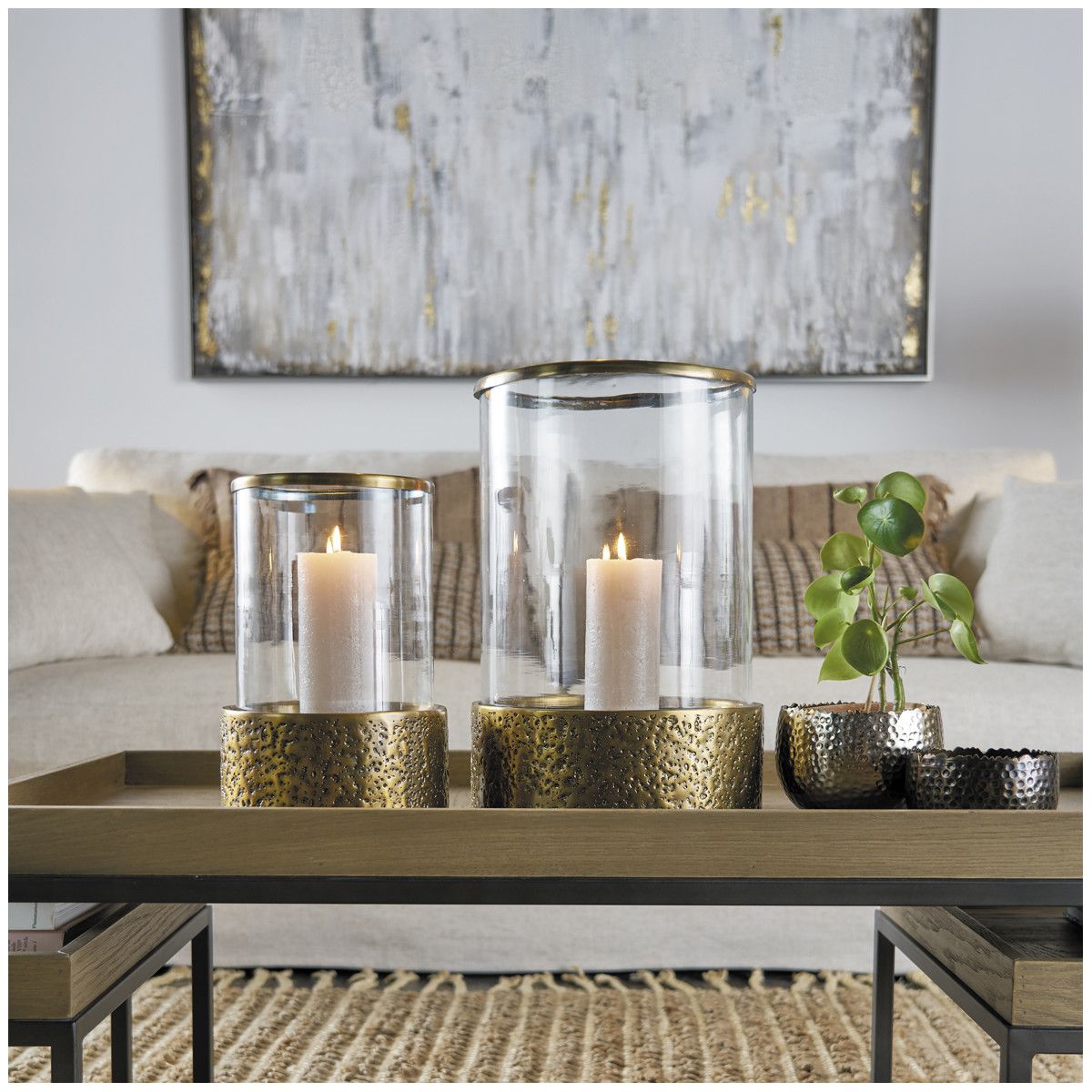 Lantern with textured brass base and cylindrical glass frame
