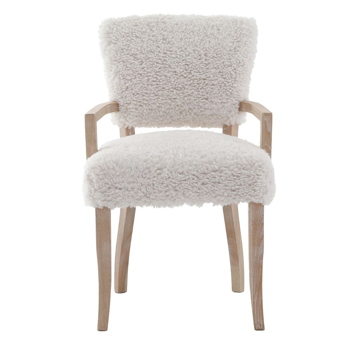 The Winnie Dining Armchair, with its faux sheepskin upholstery and solid oak frame, adds Alpine elegance and comfort, featuring solid oak arms for added support.