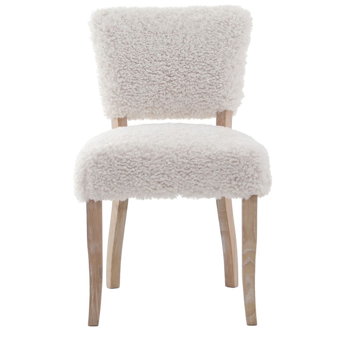 The Winnie Dining Chair, upholstered in faux sheepskin and set on a solid oak frame, brings Alpine charm and style to your dining room.