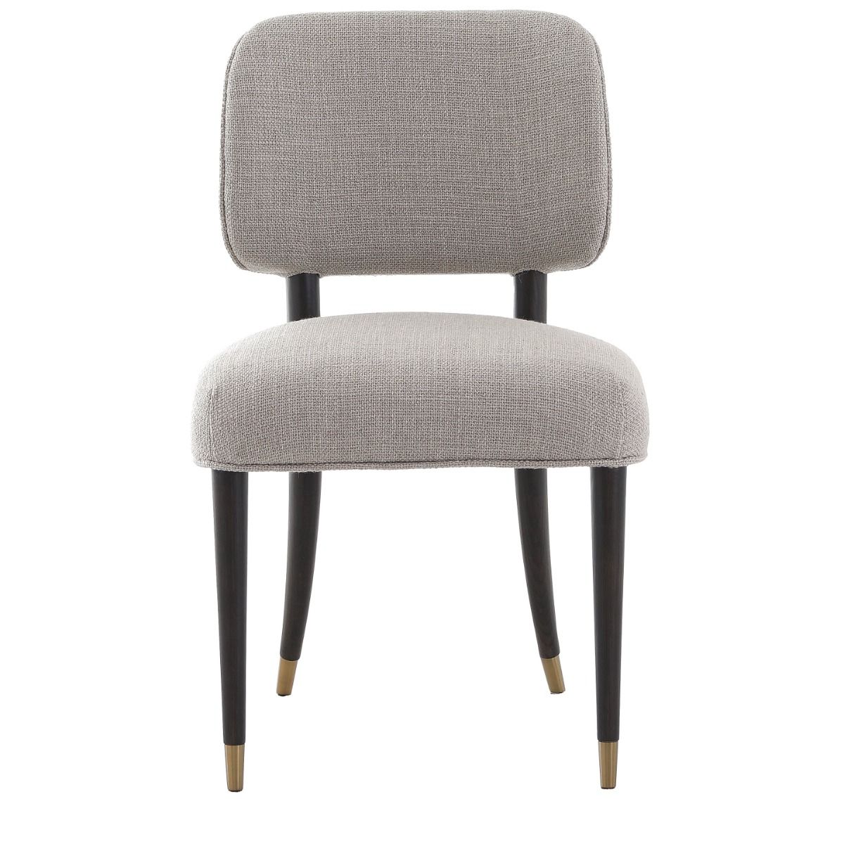 The Cheltenham Dining Chair, upholstered in luxurious linen with a solid oak frame and brass-capped feet, adds timeless elegance to any dining table.