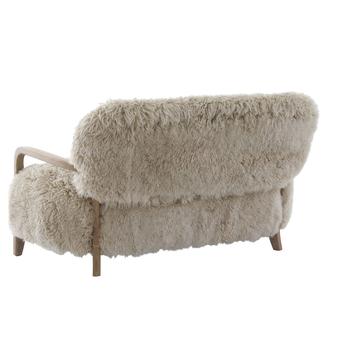 Upholstered in luxurious sheepskin with curved oak arms, the Baaarb Sofa adds a refined yet edgy touch to any modern interior and pairs perfectly with the Baaarb Accent Chair and Ottoman.