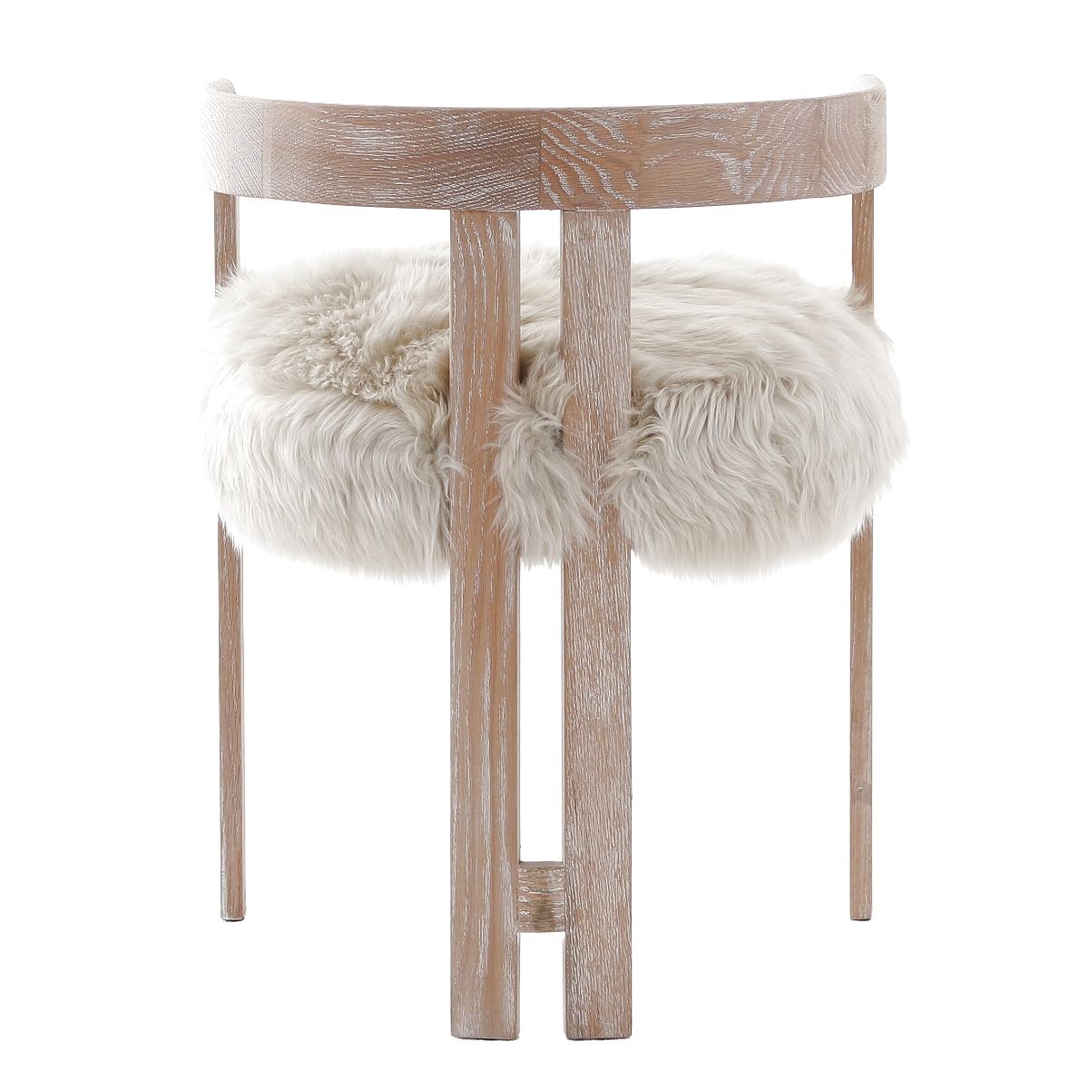 The Baaarb Dining Chair, with its real cream sheepskin seat and solid oak frame, exudes luxurious contemporary style and texture, making it a striking addition to any dining space.