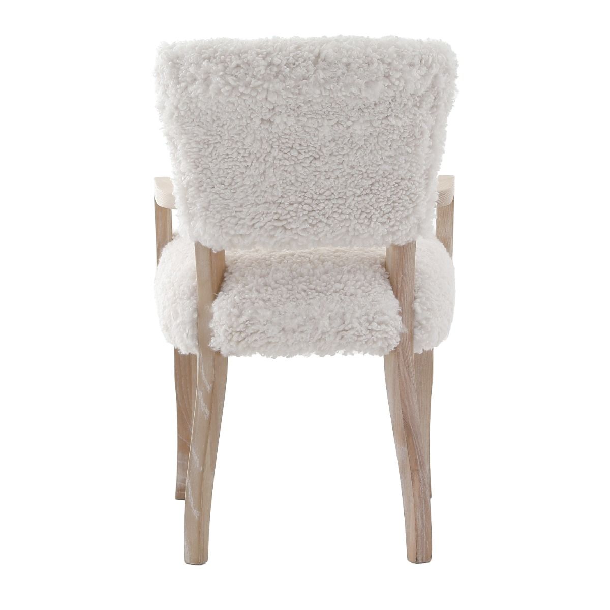 The Winnie Dining Armchair, with its faux sheepskin upholstery and solid oak frame, adds Alpine elegance and comfort, featuring solid oak arms for added support.