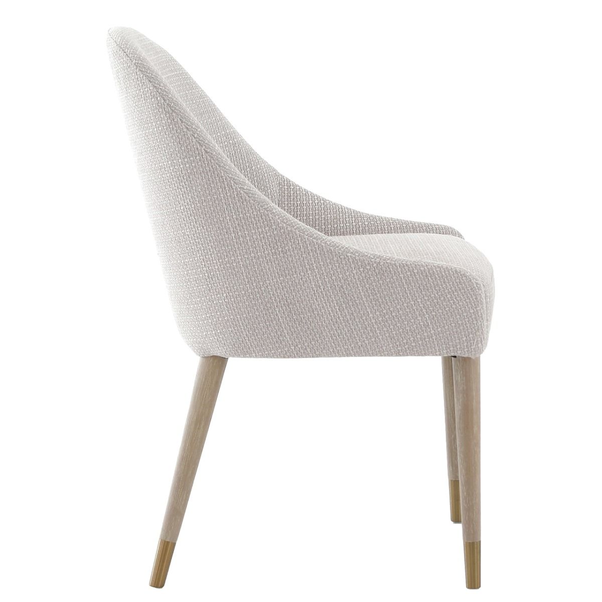 The Bibury Dining Chair features sleek sloped arms, a rounded frame, and solid wood legs with brass golden caps, providing both comfort and style.