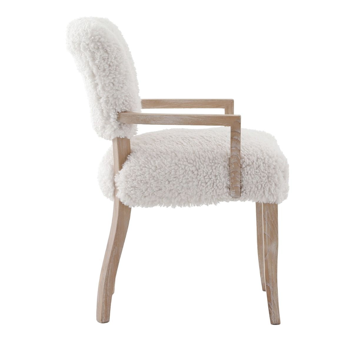The Winnie Dining Armchair, with its faux sheepskin upholstery and solid oak frame, adds Alpine elegance and comfort, featuring solid oak arms for added support.