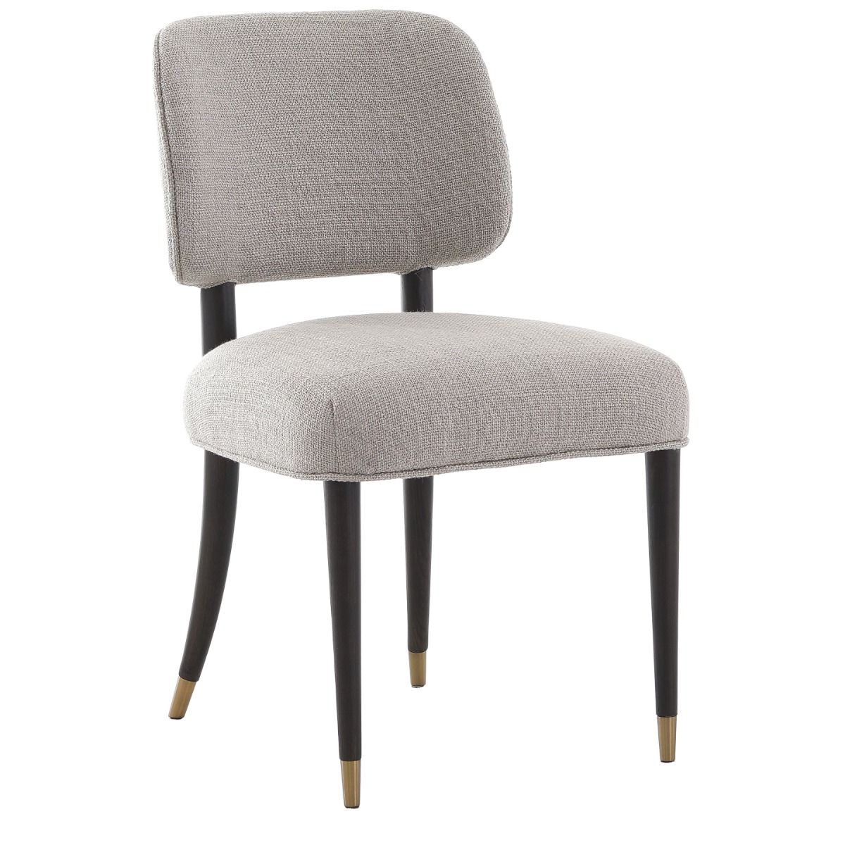 The Cheltenham Dining Chair, upholstered in luxurious linen with a solid oak frame and brass-capped feet, adds timeless elegance to any dining table.