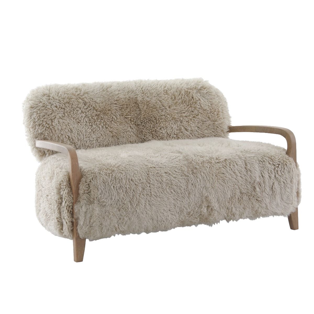 Upholstered in luxurious sheepskin with curved oak arms, the Baaarb Sofa adds a refined yet edgy touch to any modern interior and pairs perfectly with the Baaarb Accent Chair and Ottoman.