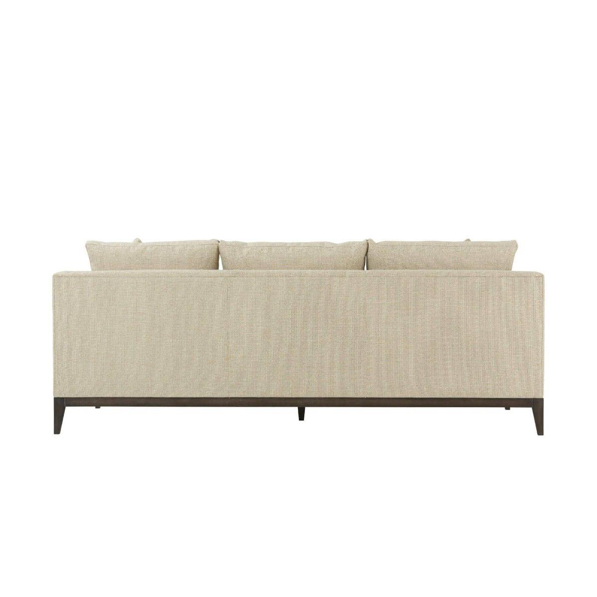 Natural upholstered three seater sofa with dark brown wooden legs