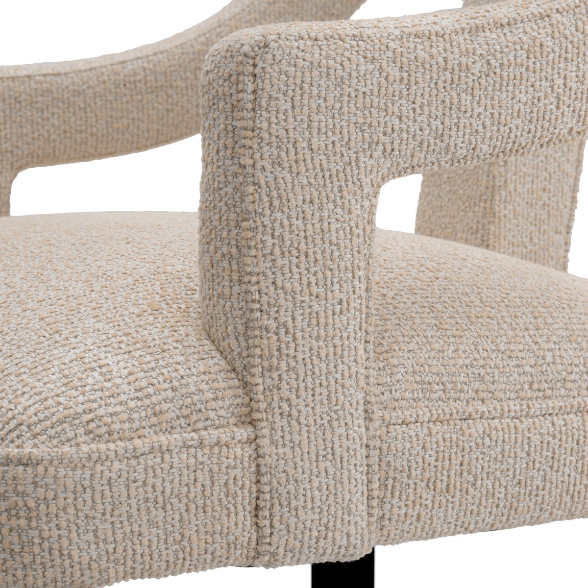 A stylish dining chair with a distinctive silhouette and luxury beige upholstery