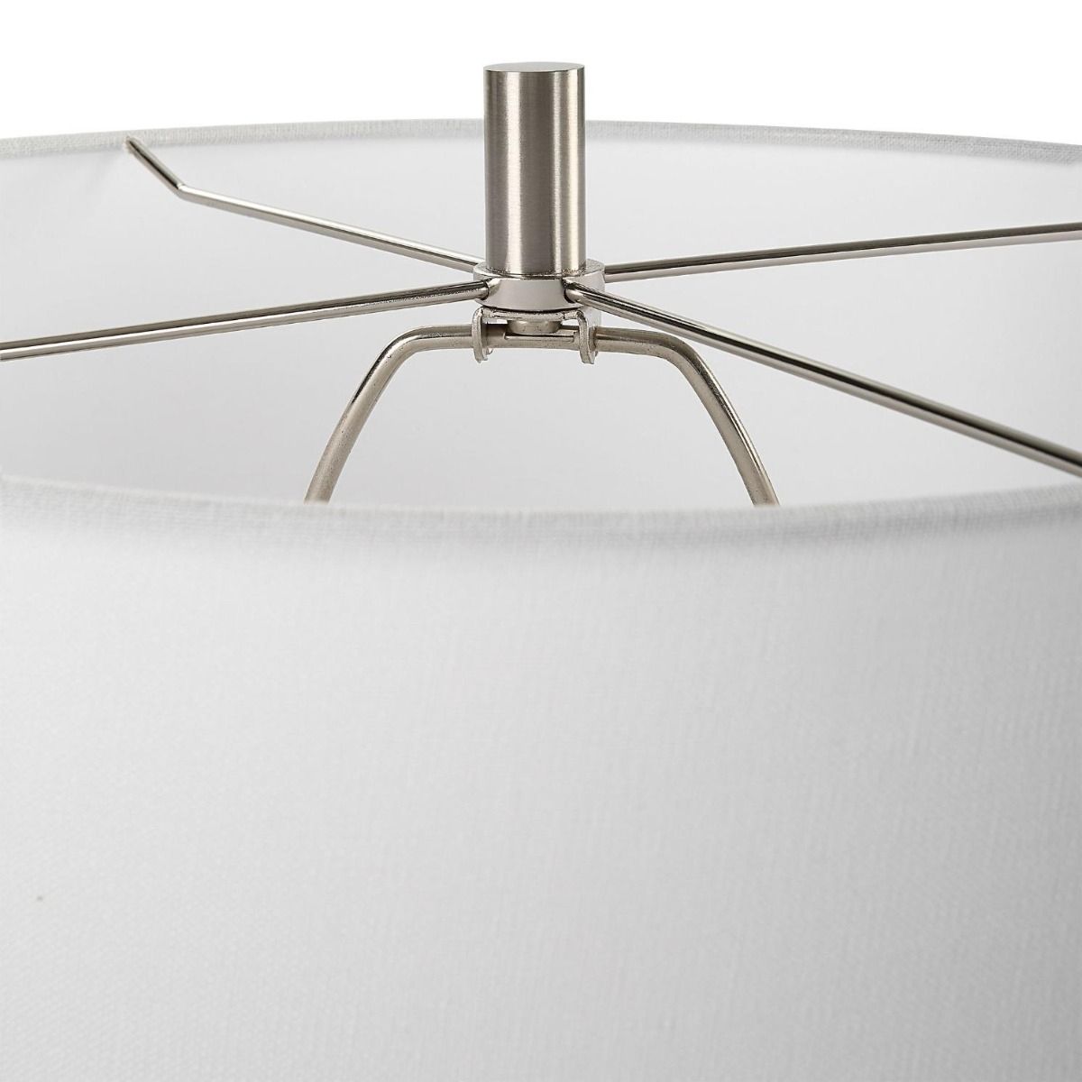 This tapered ceramic lamp has a distressed off-white finish, brushed nickel accents, and a white linen shade, adding timeless elegance to any space.