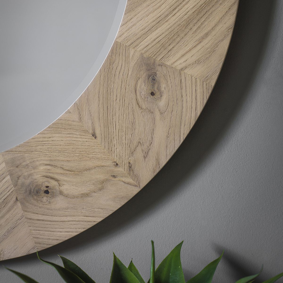 Warm wooden circular mirror with chevron design