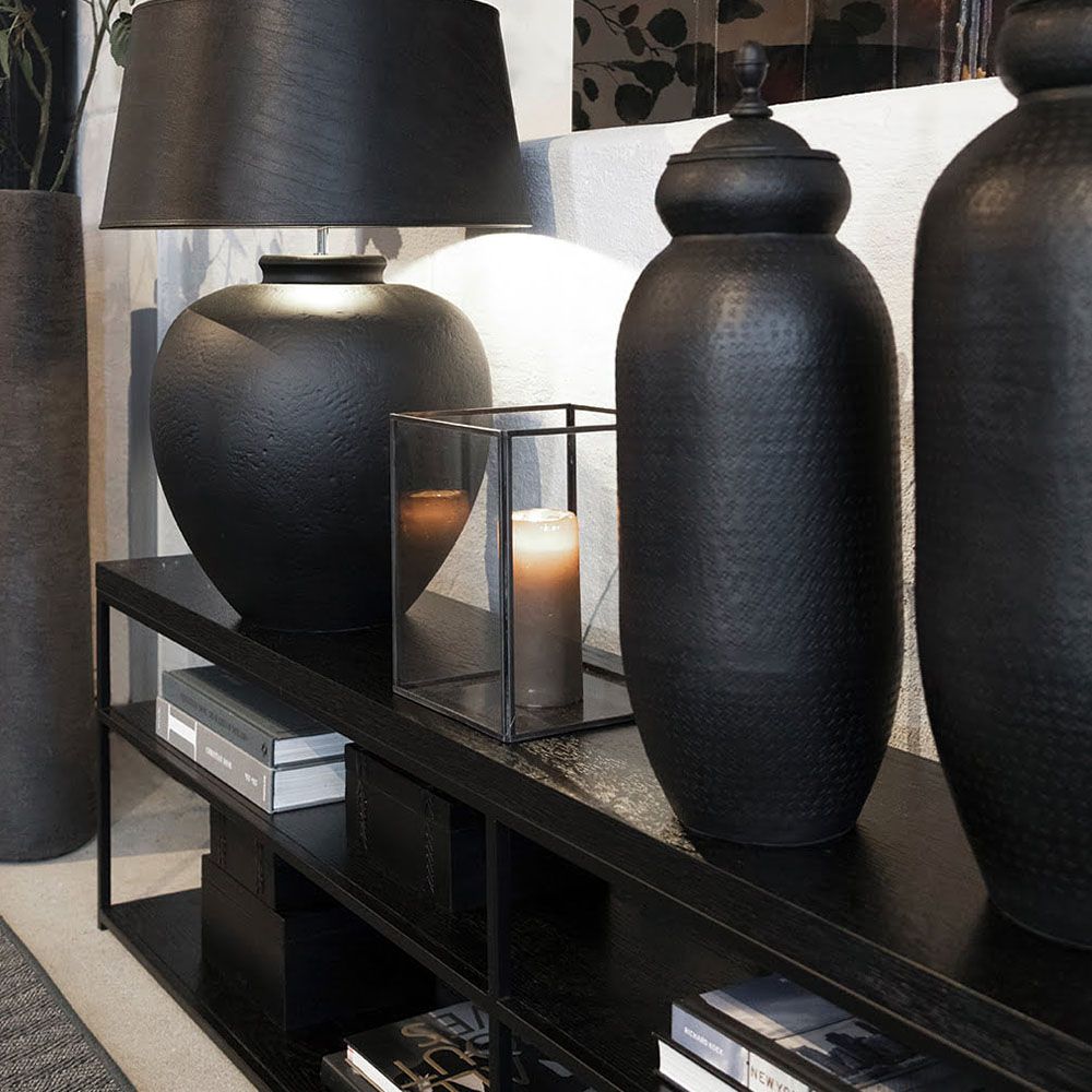 Black console table with metal frame and multiple shelves