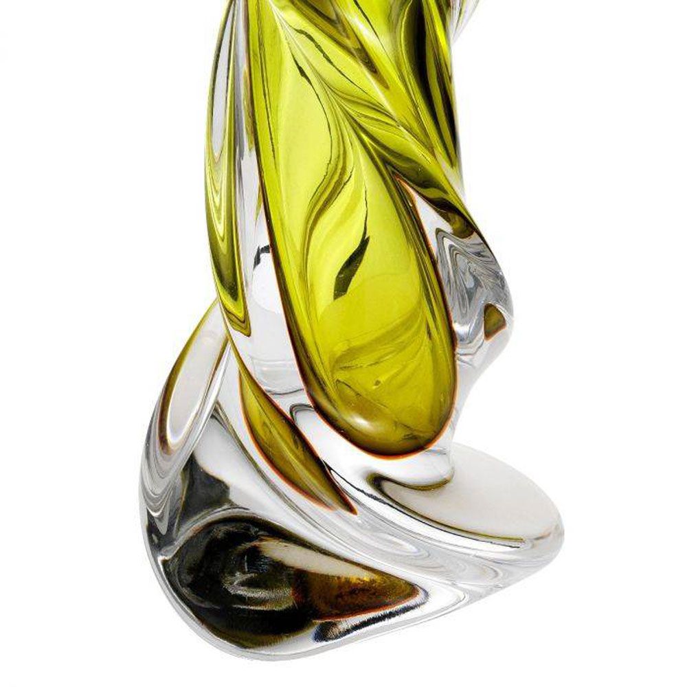 A luxurious hand blown glass lamp with a green tint and matching shade