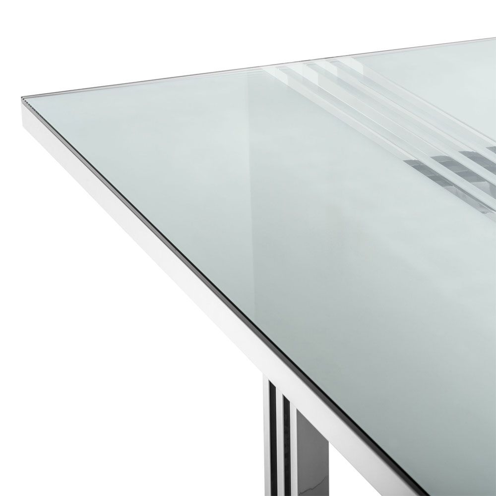 contemporary dining table with transparent surface and stainless steel frame