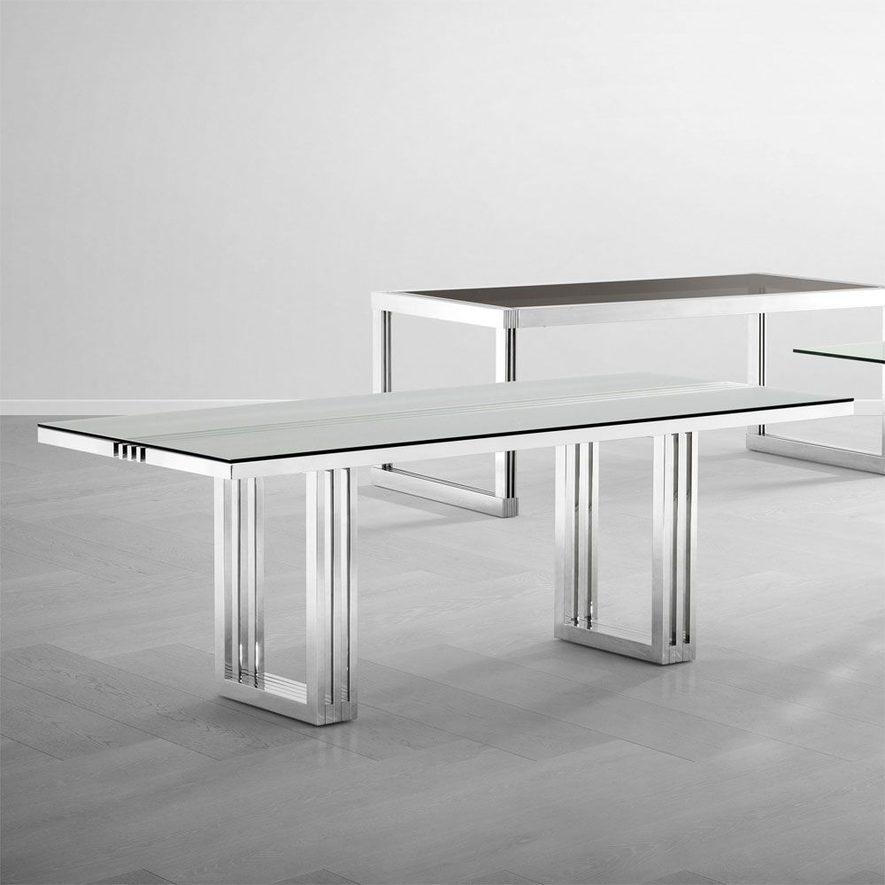 contemporary dining table with transparent surface and stainless steel frame
