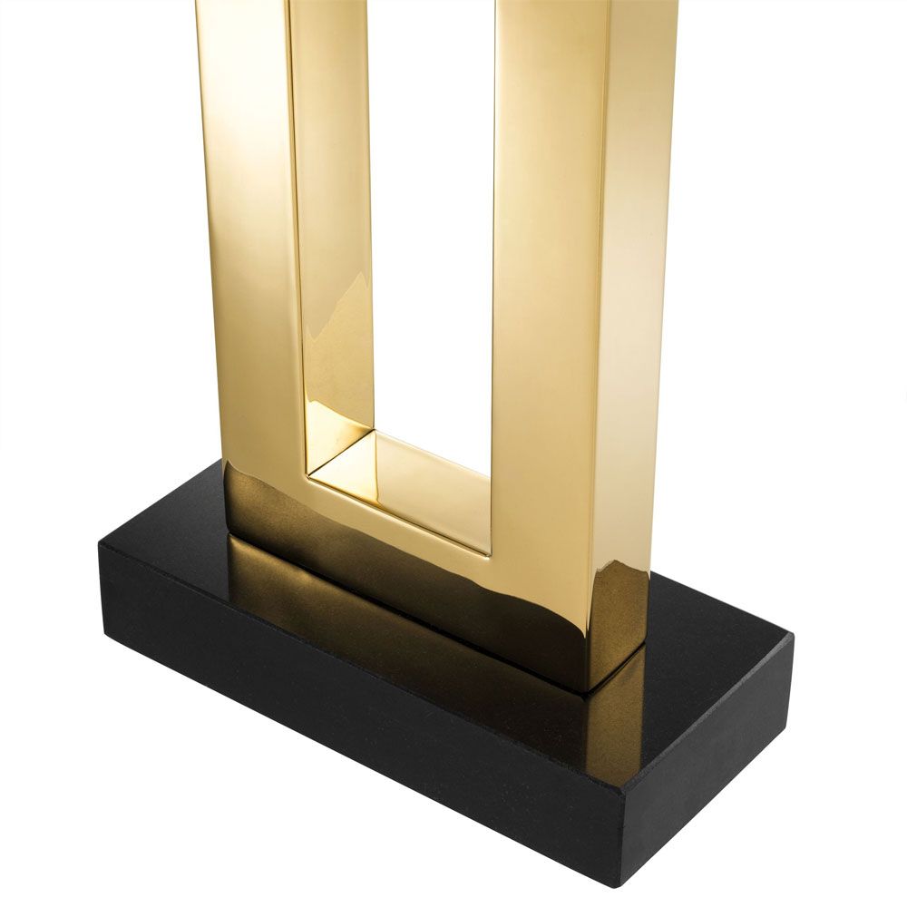 A luxurious golden table lamp with a black base and shade