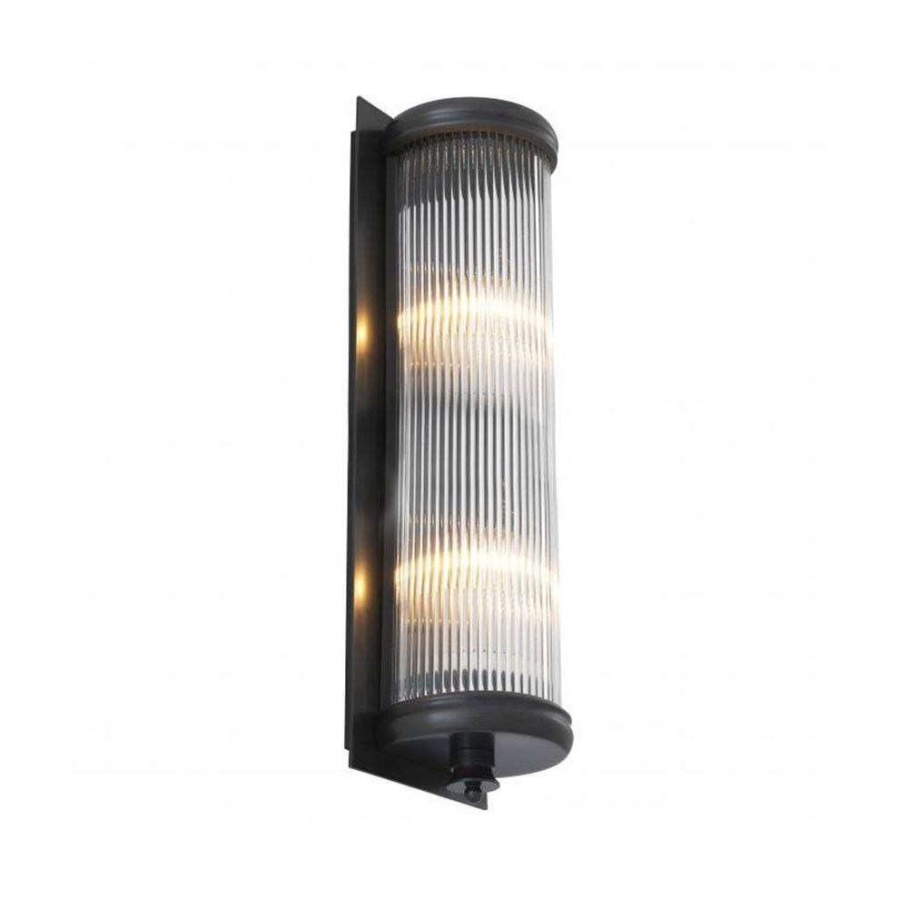 A luxurious matte bronze wall lamp with clear reeded glass 