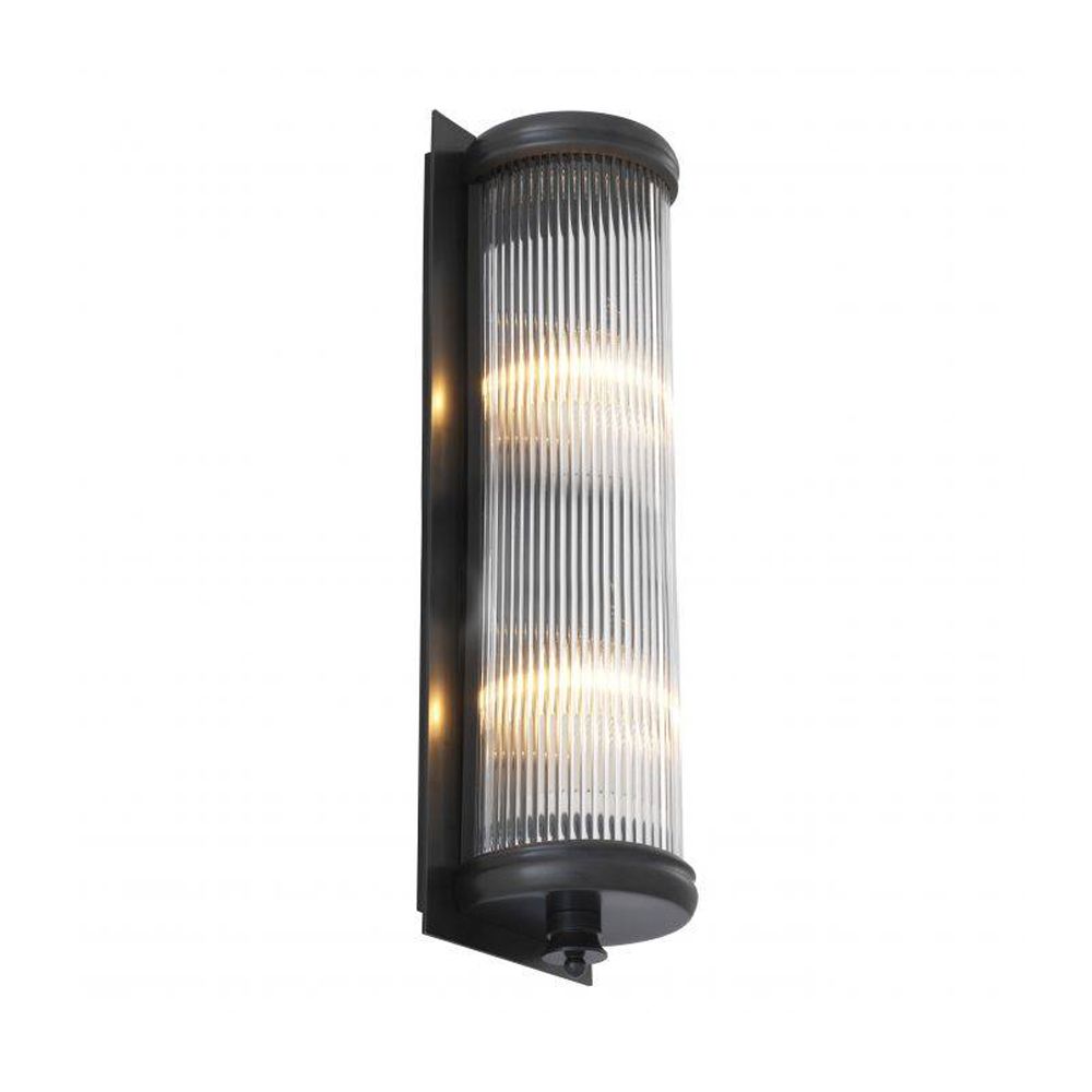 A luxurious matte bronze wall lamp with clear reeded glass 