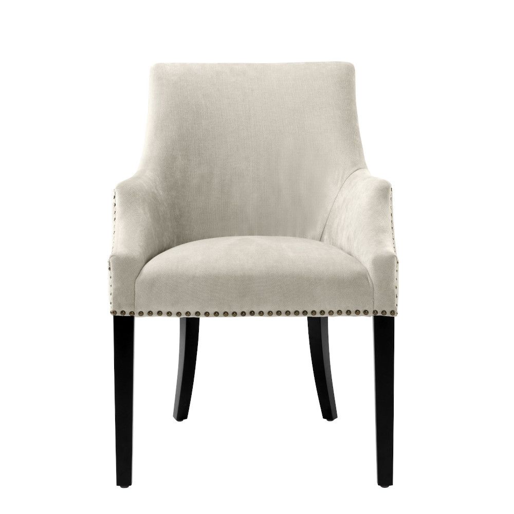 Luxury sand velvet dining chair with antique brass nail detailing and black legs
