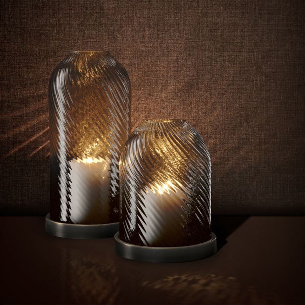 A luxury hurricane candle holder by Eichholtz with a bronze finish