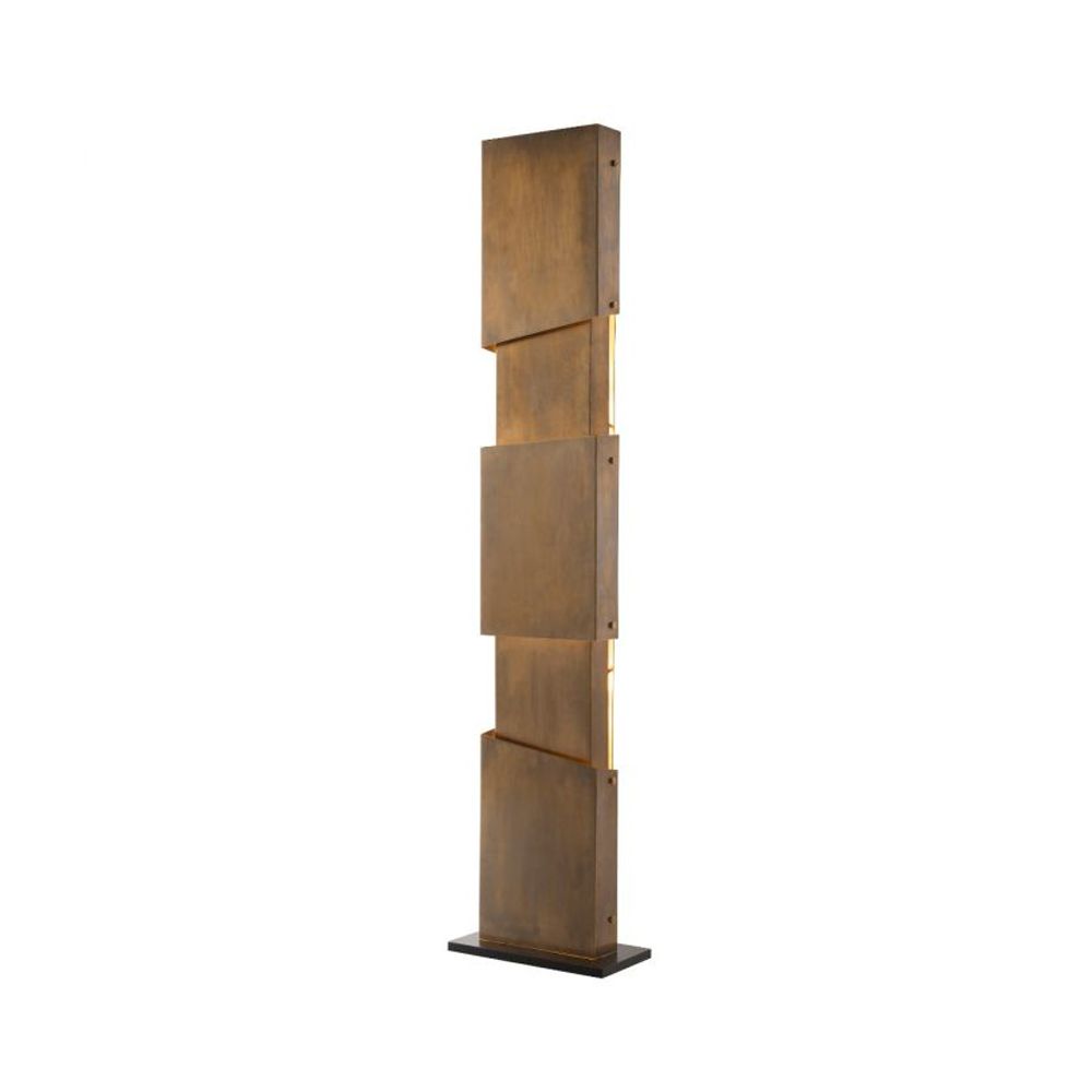 A chic industrial style floor standing lamp in a vintage brass finish