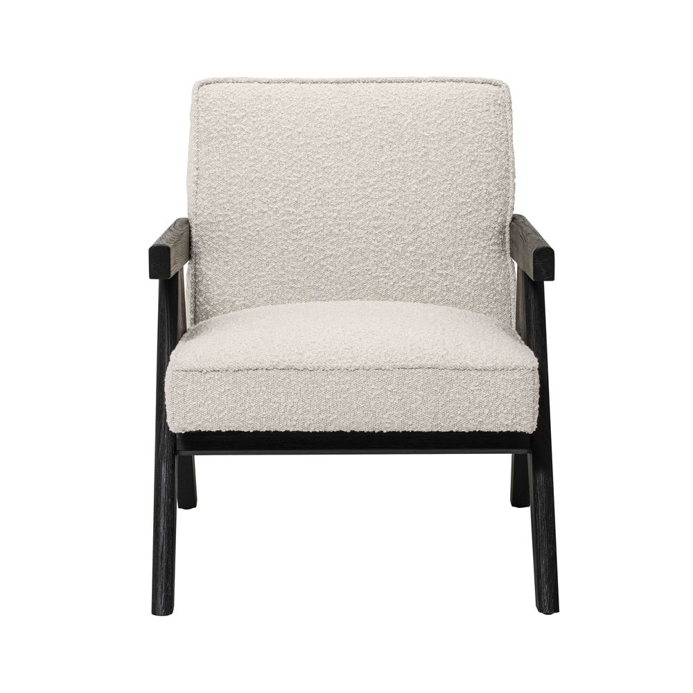 A luxurious boucle armchair with black legs 