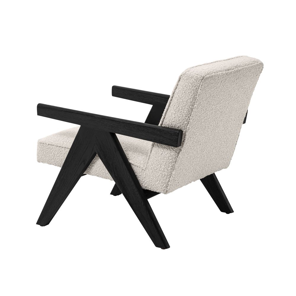 A luxurious boucle armchair with black legs 