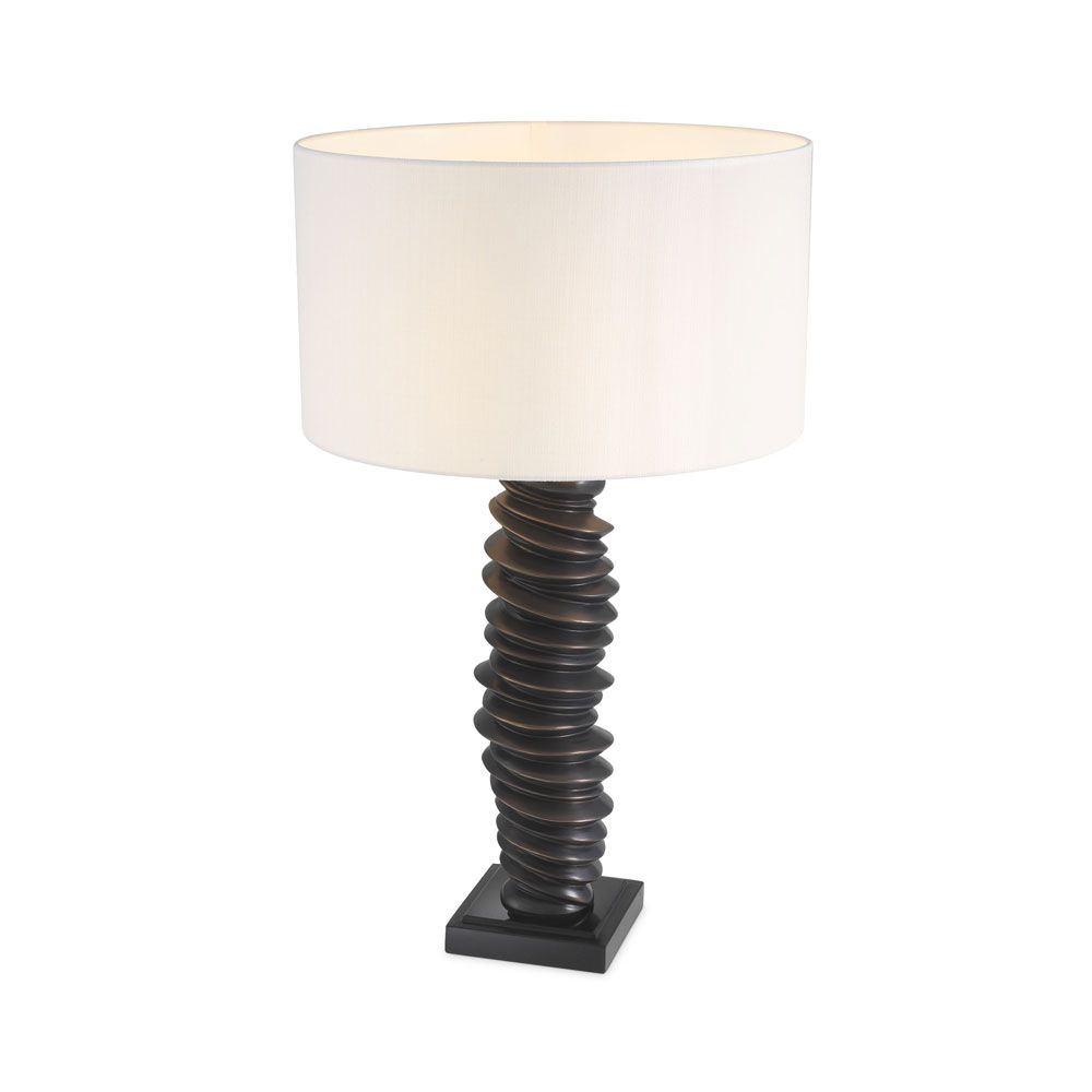 A luxurious bronze table lamp with a natural-toned lampshade