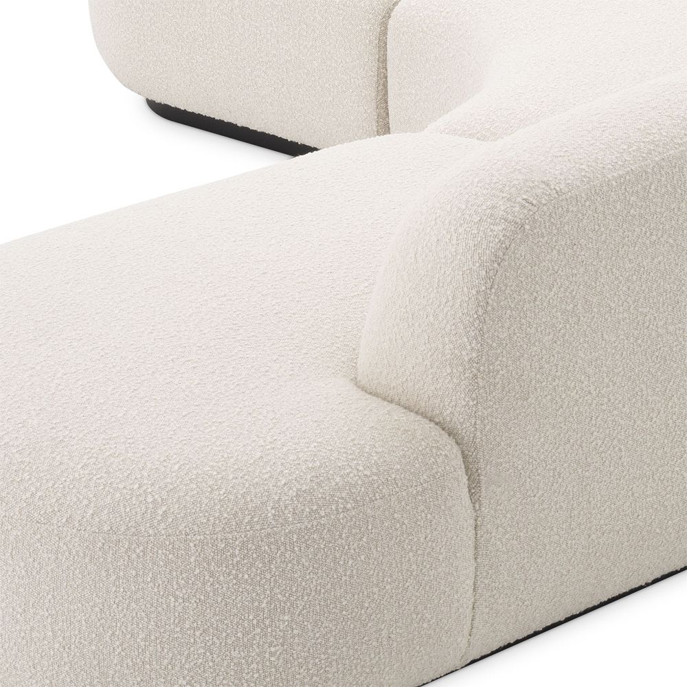An exquisite, contemporary curved sofa with boucle upholstery