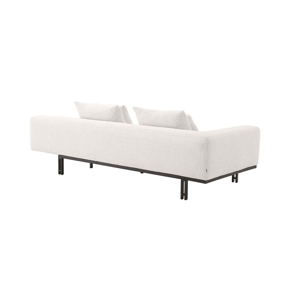 A functional two seater sofa by Eichholtz with a modern off-white upholstery, a bronze base and an integrated side table