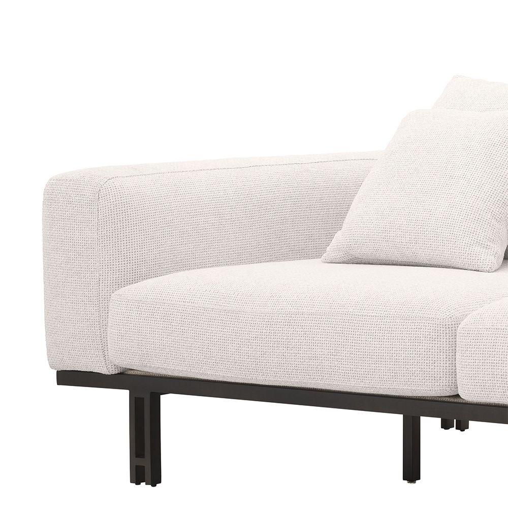 A functional two seater sofa by Eichholtz with a modern off-white upholstery, a bronze base and an integrated side table