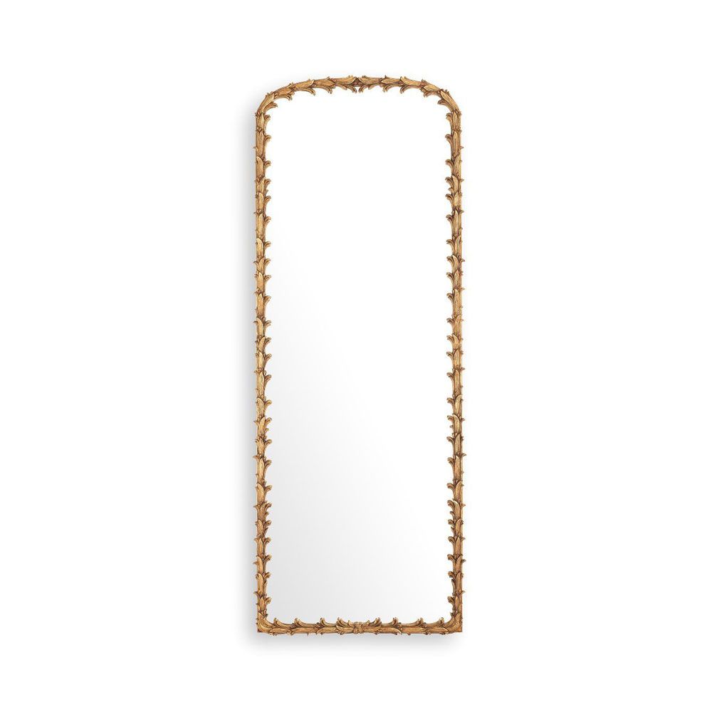 An elaborate vintage brass wall mirror with intricate leaf detailing
