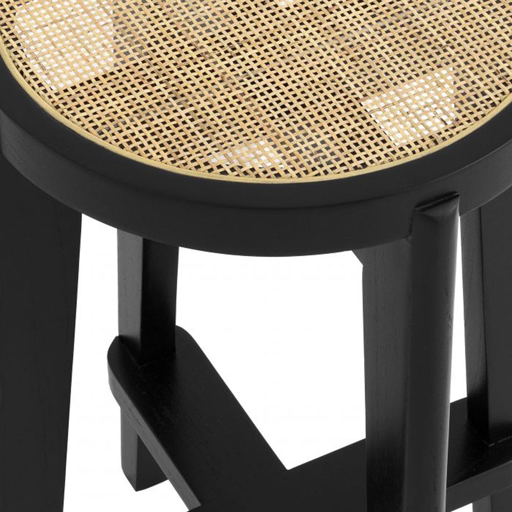 A chic Scandinavian-inspired rattan counter stool with a black finish