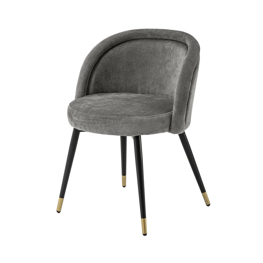 A luxurious set of two velvet dining chairs with black tapered legs and golden caps